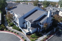 aerial view of multi-family dwelling unit showing rooftop and area landscaping