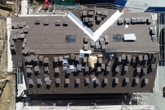 bird's eye view of roof finish materials stacked on a rooftop ready for installation