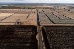 aerial view of empty lots prepared for construction with open land in the background