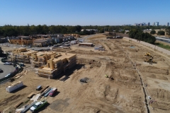 aerial view of a development site with buildings and lots at various stages of construction