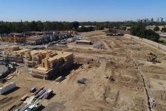 aerial view of development site showing buildings and lots at different stages of construction